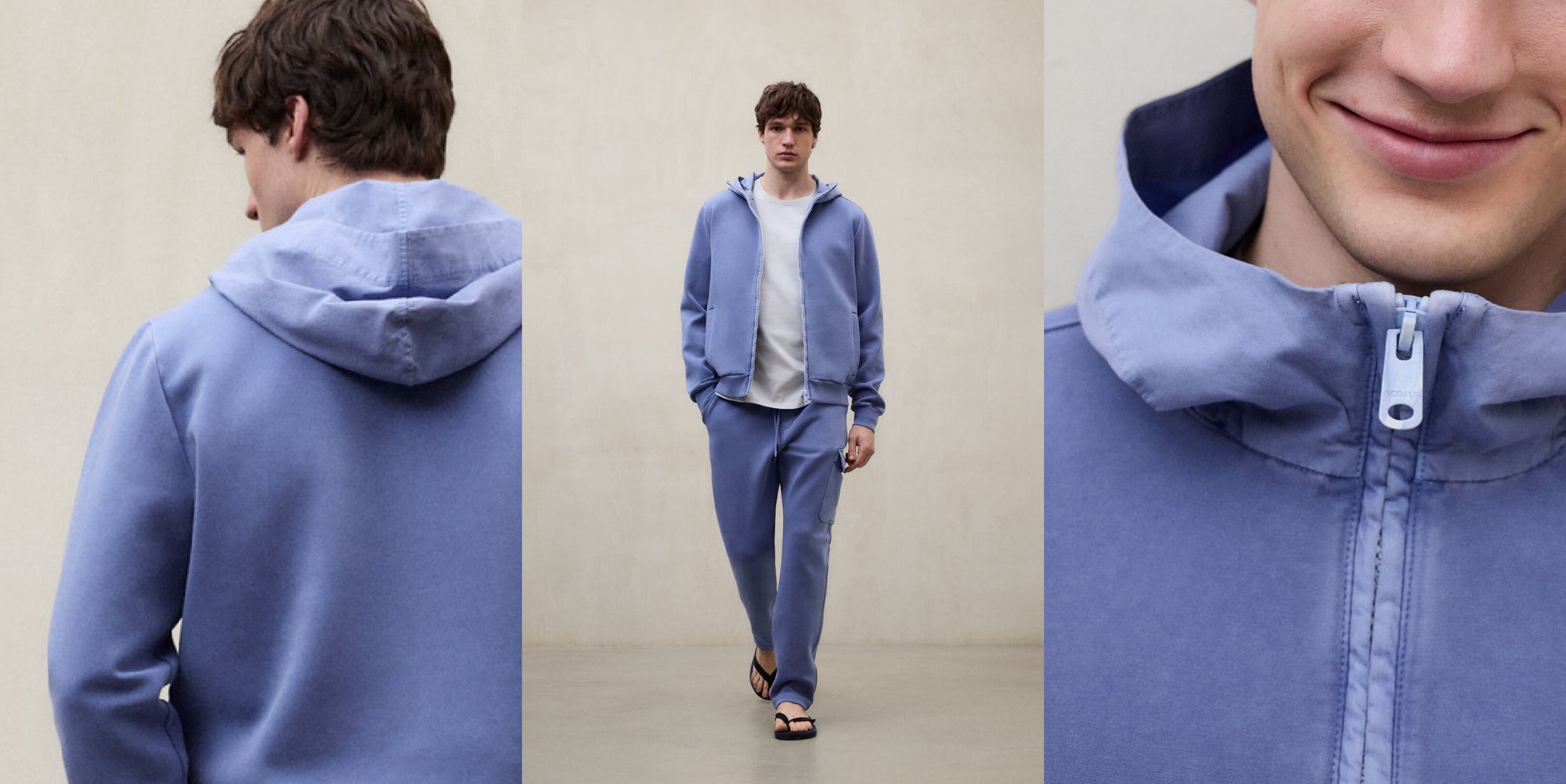 Un hombre con un conjunto de Ecoalf azul claro de sudadera con capucha, pantalón a juego y sandalias, caminando hacia la cámara.