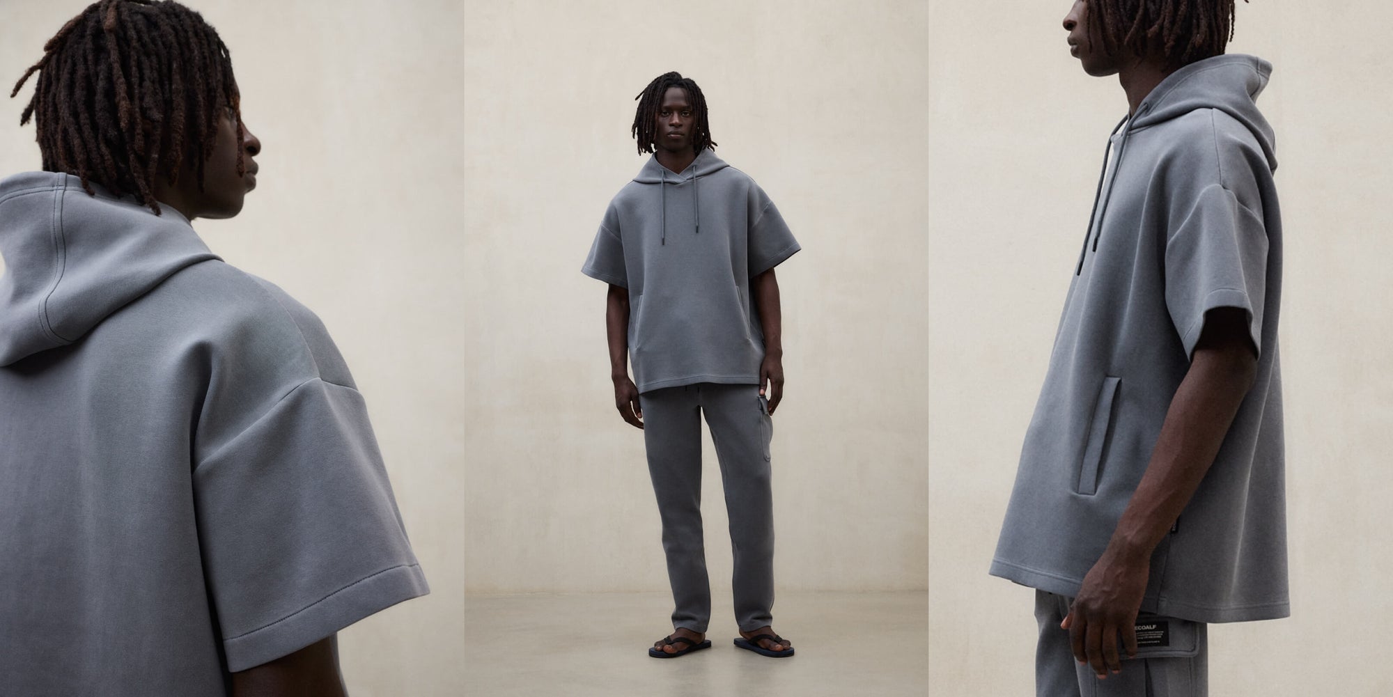 Un hombre con un conjunto de Ecoalf gris de sudadera de manga corta y pantalón.